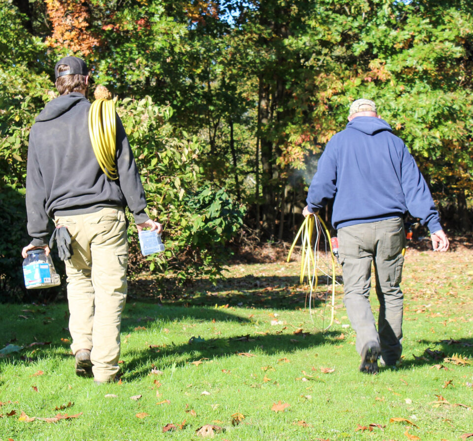 Electrician walking away from completed electrical job with tools in hand