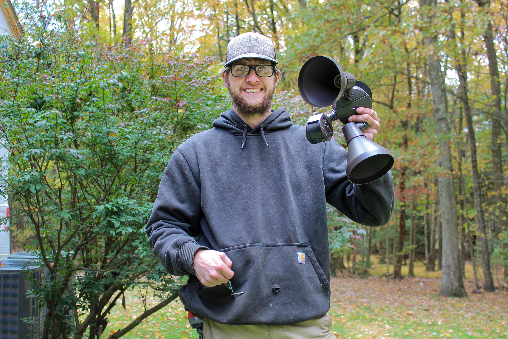 Electrician showing an outdoor light fixture to a client before installation highlighting professional consultation and quality electrical services